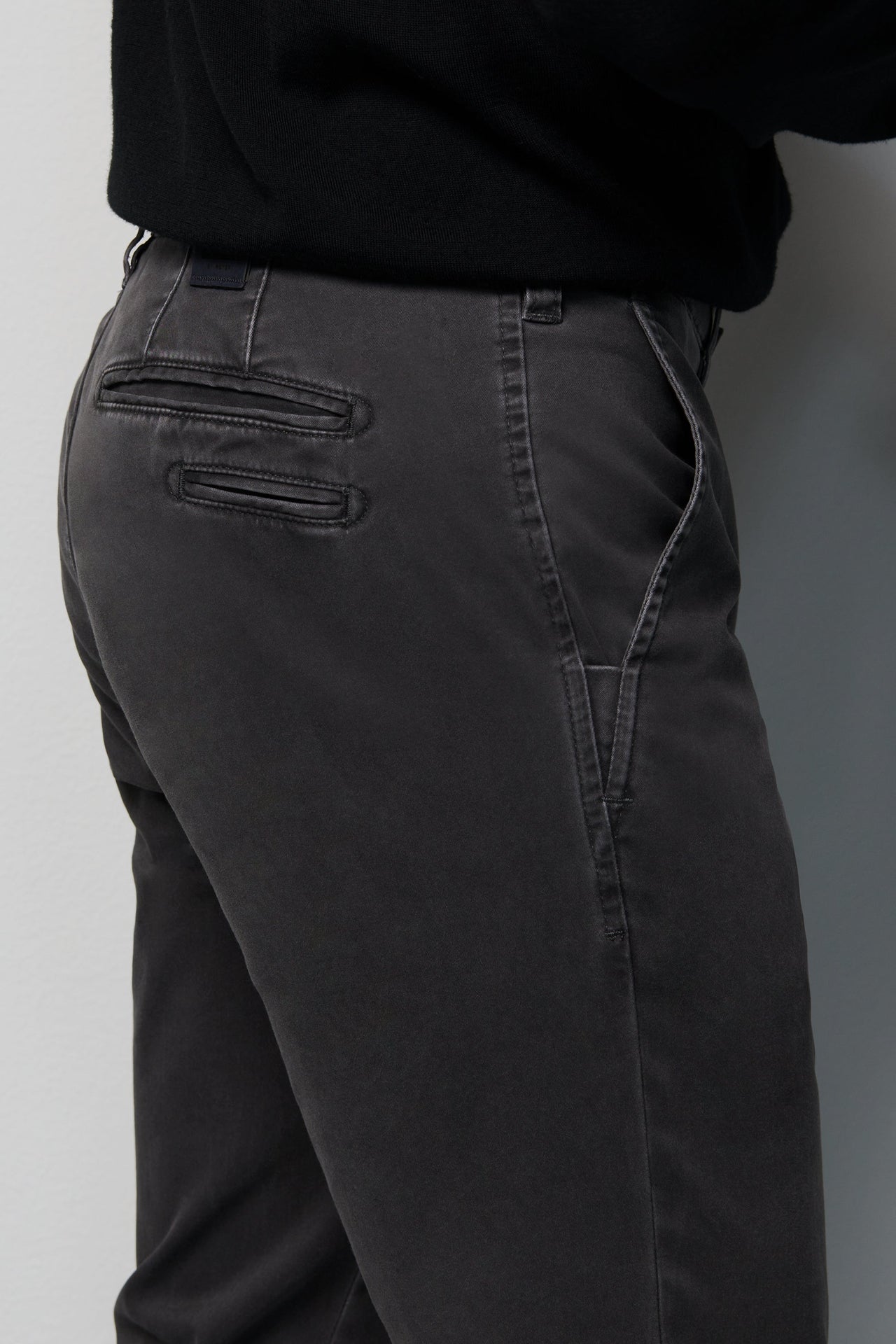 Dark gray pants with a plain background